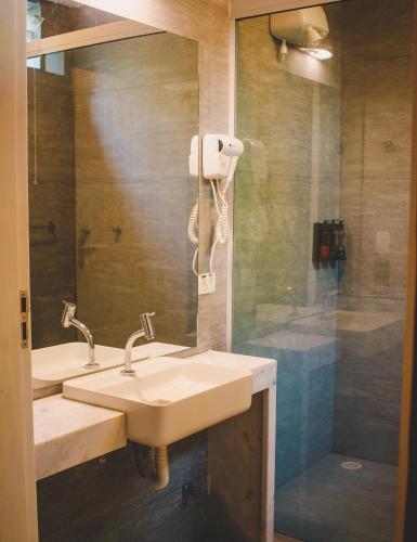 a bathroom with a sink and a shower at Alua Camburi in Camburi