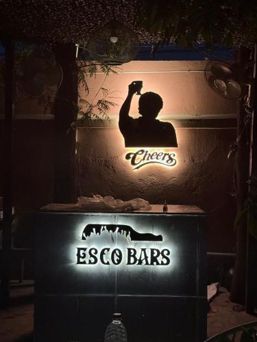 a sign for eso bar with a man taking a picture at Sariska Haveli in Alwar
