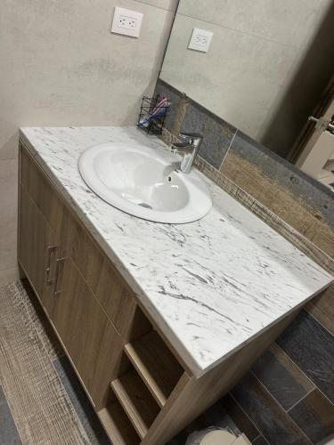 a bathroom sink with a white marble counter top at Little friend #1 Two balconies,elevator in Boca Chica