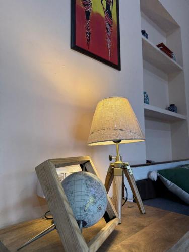 a table with a globe and a lamp on it at Sariska Haveli in Alwar