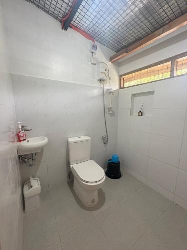 a bathroom with a toilet and a sink at Cloudrest Marilog in Kayagan