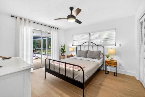 a bedroom with a bed and a ceiling fan at Spacious Clearwater House 4BR 3BA Private Pool in Clearwater