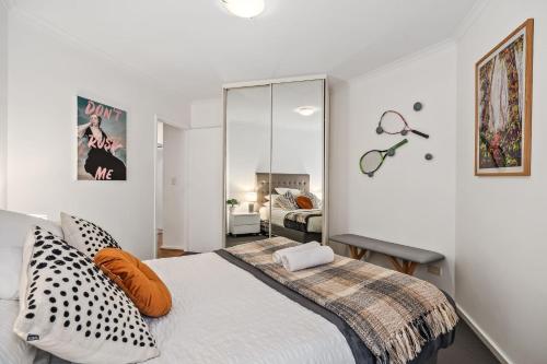 a bedroom with a bed and a mirror at Carrington Views - 3 Bedrooms - CBD - Parking in Adelaide
