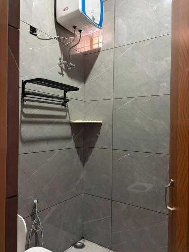 a bathroom with a shower stall with a toilet at Aura by bala in Dehradun