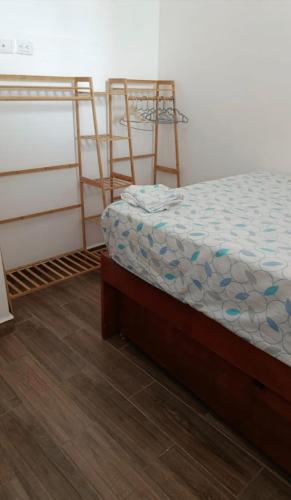 a bedroom with two bunk beds and a wooden floor at Coastal Charm in Ixtapa