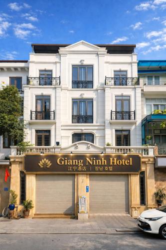 a white building with a sign in front of a store at Giang Ninh Hotel - Korean Town Bac Ninh in Bồ Sơn