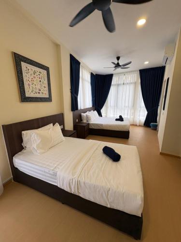 a bedroom with two beds and a ceiling fan at Tdoze Hotel At Piccadilly Ipoh in Ipoh