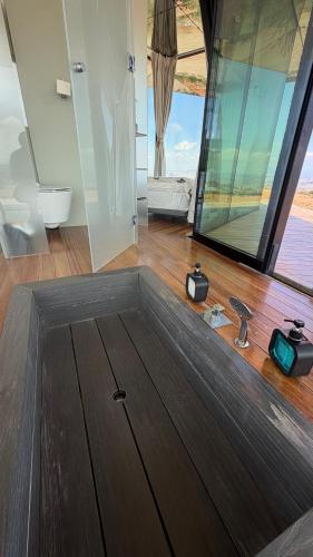 a bathroom with a toilet and a large window at La Casa del Desierto in Gorafe