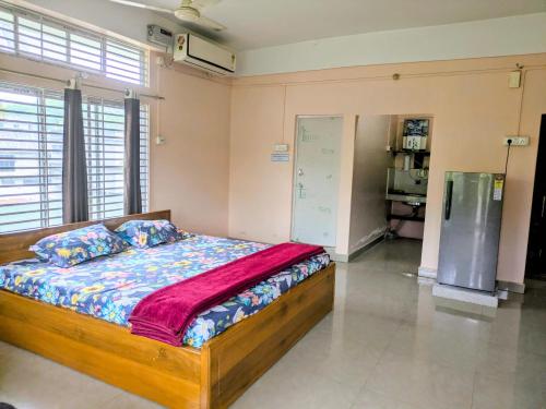 a bedroom with a wooden bed in a room at Gogona Homestay in Guwahati