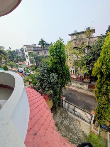 a view of a red brick walkway with buildings in the background at Gogona Homestay in Guwahati