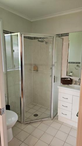 a bathroom with a shower and a sink at Canberra Stylish Escape in Harrison