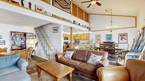 a living room with a couch and a table at Lakeside Getaway Beach Access Shared Pool and Grills in McCall