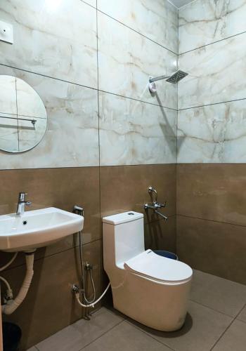 a bathroom with a toilet and a sink at Myday Inn by Znormhomes in Varkala