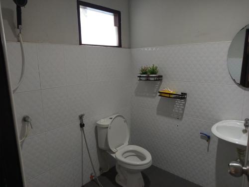 a bathroom with a toilet and a sink at 4Hearts Hotel in Suratthani