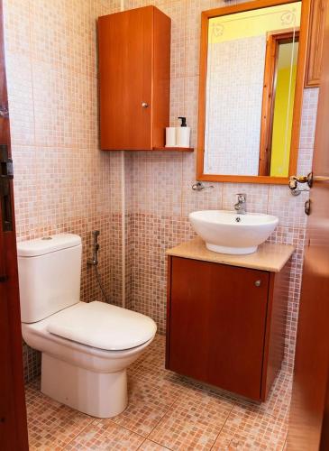 a bathroom with a toilet and a sink at Villa Victoria Ayia Napa in Ayia Napa