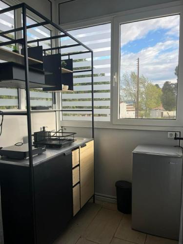 a kitchen with two large windows and a counter top at LaMar in Skala Prinou