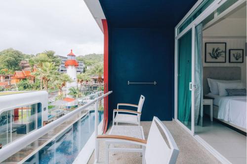 a balcony with a bed and a bedroom with a view at Sugar Marina Hotel - NAUTICAL - Kata Beach in Kata Beach