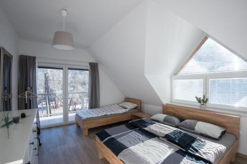 a bedroom with a bed and a window at Apartments Teja in Kranjska Gora