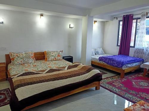 a bedroom with a bed and a couch in it at Sat Chit Ananda bhavan in Darjeeling