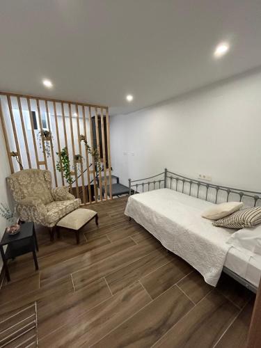 a bedroom with a bed and a chair at Carmen La Golondrina in Restábal