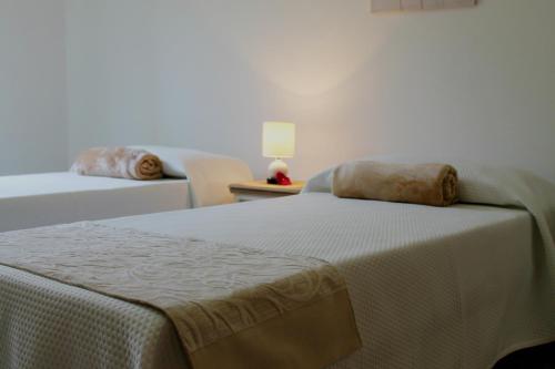 Postel nebo postele na pokoji v ubytování B&B Le Orchidee