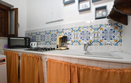 a kitchen with a sink and a stove at 1 Bedroom Beautiful Apartment In Trappeto in Trappeto
