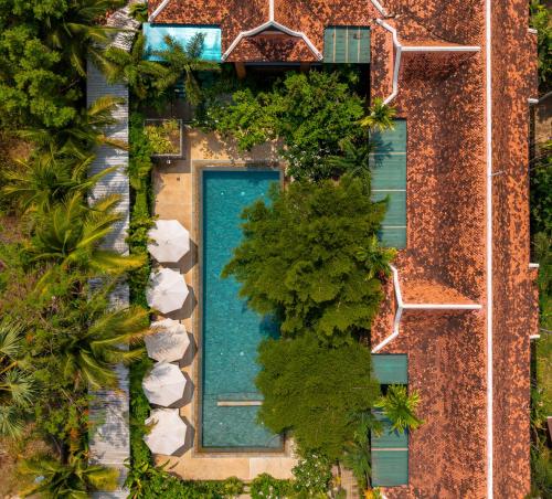 an overhead view of a swimming pool with trees at Khmer House Resort in Siem Reap
