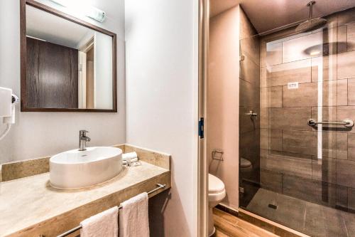 a bathroom with a sink and a shower at Sleep Inn Ciudad de Mexico Cuajimalpa in Mexico City