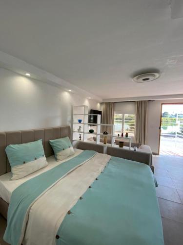 a large bedroom with a large bed and a couch at Le Cocon de Didon in Tunis
