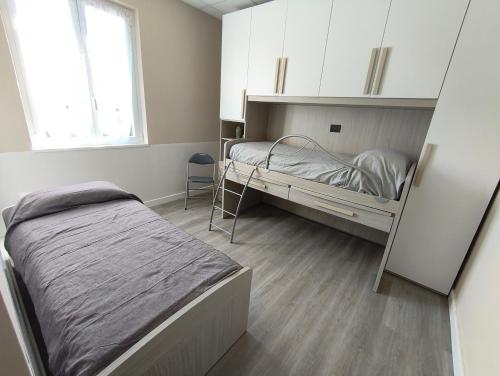a bedroom with two bunk beds and a window at Ca' da Lisa in San Colombano Certenoli