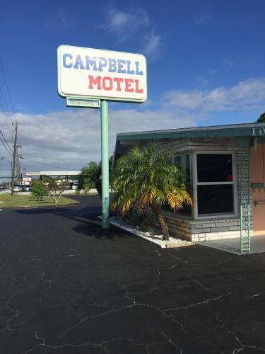 una señal para un motel Campbell en un estacionamiento en Campbell Motel, en Cocoa