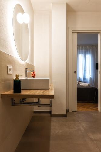 a bathroom with a sink and a mirror at Boccaccio Apartment 3 in Ravenna