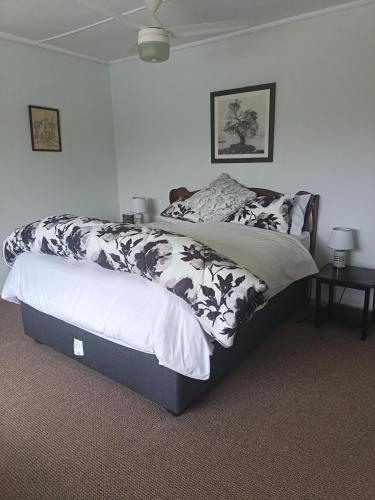a bedroom with a bed with a black and white comforter at Chickpea Villa in Bergview