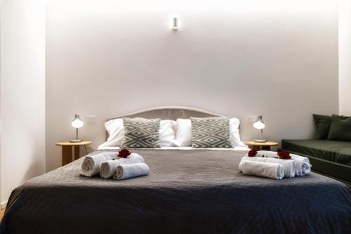 a bedroom with a bed with towels on it at Boccaccio Apartment 3 in Ravenna