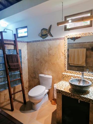 a bathroom with a toilet and a sink at Villa Murni in Lovina