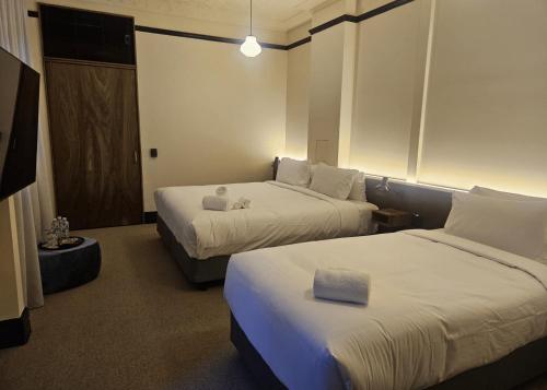 a hotel room with two beds in a room at Mercantile Hotel in Sydney