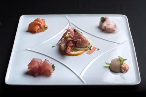 a white plate with different types of food on it at Villa Franceschi Hotel & Resort in Mira