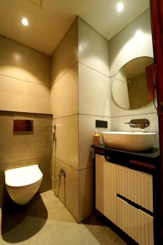a bathroom with a sink and a toilet and a mirror at Hotel the republic in Zirakpur