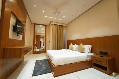 a bedroom with a large bed and a television at Hotel the republic in Zirakpur