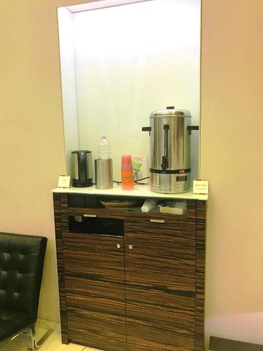 a mirror on a cabinet with a coffee maker on it at Ibis Styles Milano Centro in Milan