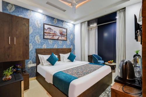 a hotel room with a bed and a tv at Hotel Priyaj Newly Built with Luxury Restaurant in Jaipur