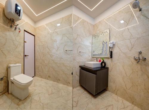 a bathroom with a toilet and a shower and a sink at Hotel Priyaj Newly Built with Luxury Restaurant in Jaipur
