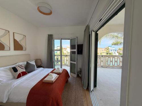 a bedroom with a large bed and a balcony at FINELINE Villa in Limassol