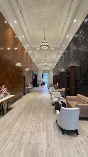 a large lobby with couches and chairs in a building at Sedra Al Alami Jeddah in Jeddah