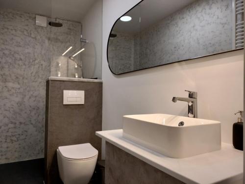 a bathroom with a white sink and a toilet at Ka6 Infinity Apartment - Vipava Valley in Ajdovščina