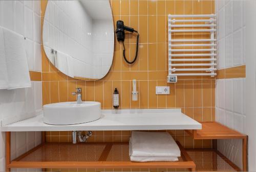 a bathroom with a sink and a mirror at Academy by Ambassadori in Kachretʼi