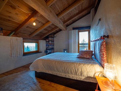 a bedroom with a bed in a room with wooden ceilings at Meira Carlevara in San Maurizio