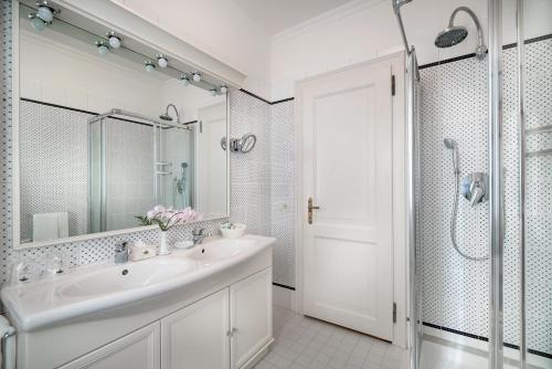 a white bathroom with a sink and a shower at Villa Margherita in Mira