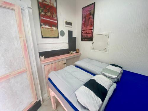 a small bed in a room with a window at Sky Stay in SJJ