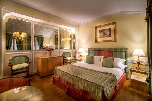 a bedroom with a bed and a table and chairs at Villa Margherita in Mira